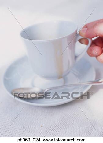 Picture - Man holding empty coffee cup, close-up . Fotosearch
