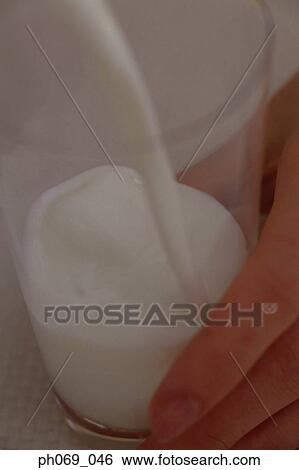 Milk pouring into glass, close-up View Large Photo Image Stock Photograph - Milk pouring into glass, close-up . Fotosearch