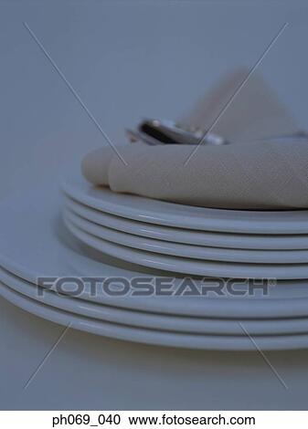 Silverware and napkin on stack of plates View Large Photo Image Stock Image - Silverware and napkin on stack of plates . Fotosearch
