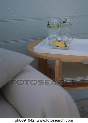 Stock Image - Two glasses of gin and tonic and lemon slices on tray. Fotosearch