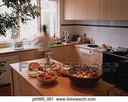 Woman at kitchen basin View Large Photo Image Stock Image - Woman at kitchen basin. Fotosearch