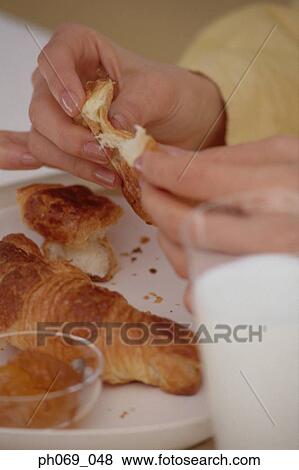 Woman holding croissant in her hands View Large Photo Image Stock Photo - Woman holding croissant in her hands. Fotosearch