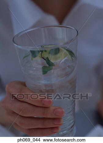 Woman toasting with gin tonic View Large Photo Image Picture - Woman toasting with gin tonic. Fotosearch