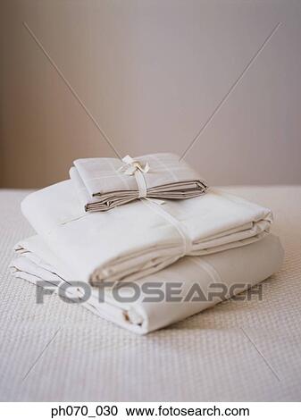 Neatly stacked fabric on the bed View Large Photo Image Stock Image - Neatly stacked fabric on the bed. Fotosearch