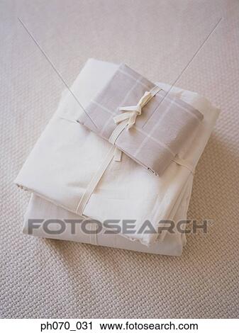 Neatly stacked fabric on the bed View Large Photo Image Stock Image - Neatly stacked fabric on the bed. Fotosearch