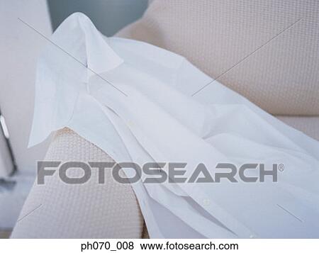 White shirt on the sofa View Large Photo Image Stock Photo - White shirt on the sofa. Fotosearch