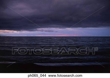 Cloudy sky and sea at sunset View Large Photo Image Picture - Cloudy sky and sea at sunset . Fotosearch
