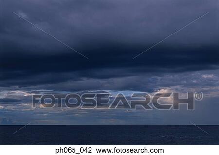 Cloudy sky and sea at sunset View Large Photo Image Stock Image - Cloudy sky and sea at sunset . Fotosearch