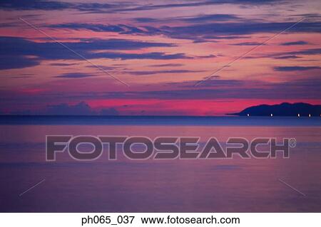 Cloudy sky and sea at sunset View Large Photo Image Stock Photo - Cloudy sky and sea at sunset . Fotosearch