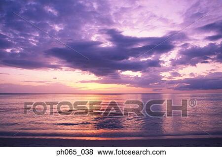 Cloudy sky and sea at sunset View Large Photo Image Stock Photo - Cloudy sky and sea at sunset . Fotosearch