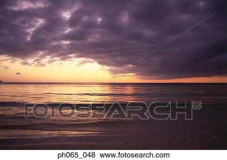 Cloudy sky and sea at sunset View Large Photo Image Stock Photo - Cloudy sky and sea at sunset . Fotosearch