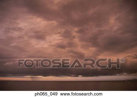 Cloudy sky and sea at sunset View Large Photo Image Stock Photo - Cloudy sky and sea at sunset . Fotosearch