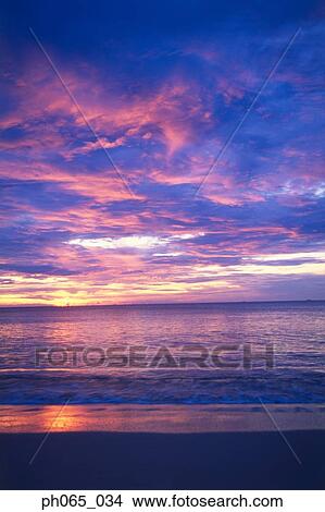 Sunset clouds over ocean View Large Photo Image Picture - Sunset clouds over ocean. Fotosearch