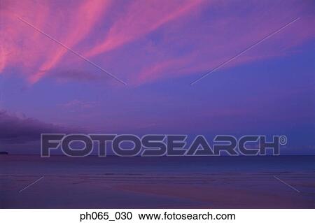 Stock Image - Sunset clouds over ocean. Fotosearch