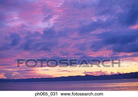 Sunset clouds over ocean View Large Photo Image Stock Image - Sunset clouds over ocean. Fotosearch