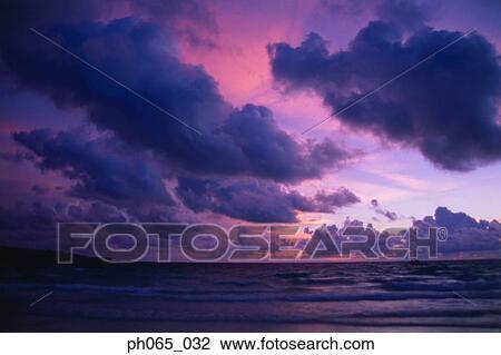Stock Image - Sunset clouds over ocean. Fotosearch