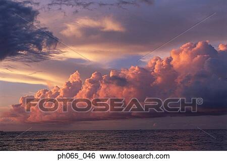Sunset clouds over ocean View Large Photo Image Stock Photograph - Sunset clouds over ocean. Fotosearch