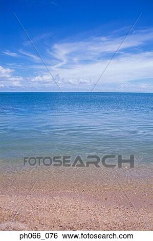Beach at low tide View Large Photo Image Stock Photograph - Beach at low tide. Fotosearch