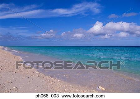 Stock Image - Cloud in blue sky over sandy beach . Fotosearch