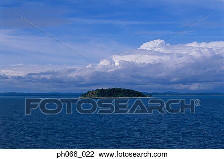 Stock Image - Island on horizon. Fotosearch