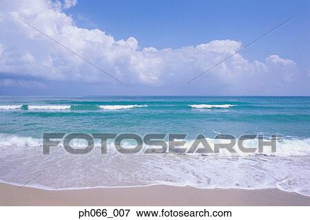 Ocean waves foaming onto sandy beach View Large Photo Image Stock Photo - Ocean waves foaming onto sandy beach . Fotosearch