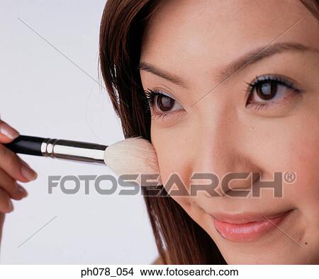 Young woman applying brusher View Large Photo Image Picture - Young woman applying brusher. Fotosearch