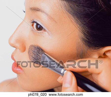 Young woman applying brusher View Large Photo Image Stock Image - Young woman applying brusher. Fotosearch