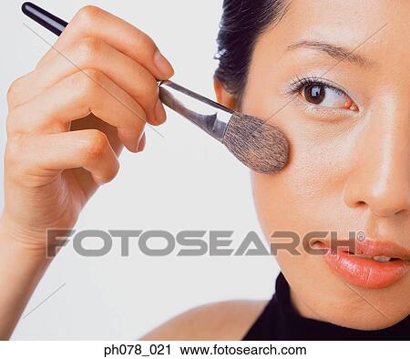 Young woman applying brusher View Large Photo Image Stock Image - Young woman applying brusher. Fotosearch