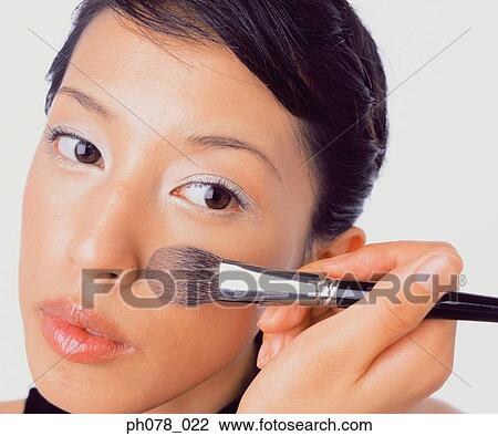 Young woman applying brusher View Large Photo Image Stock Image - Young woman applying brusher. Fotosearch