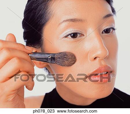 Young woman applying brusher View Large Photo Image Stock Image - Young woman applying brusher. Fotosearch