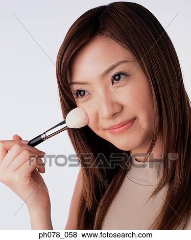 Young woman applying brusher View Large Photo Image Stock Photo - Young woman applying brusher. Fotosearch