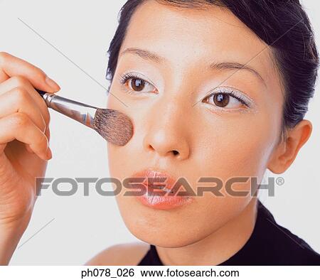 Young woman applying brusher View Large Photo Image Stock Photograph - Young woman applying brusher. Fotosearch
