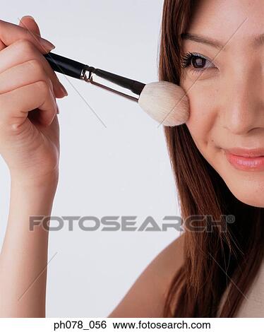 Young woman applying brusher View Large Photo Image Stock Photograph - Young woman applying brusher. Fotosearch