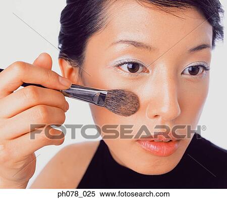 Young woman applying brusher View Large Photo Image Stock Photography - Young woman applying brusher. Fotosearch