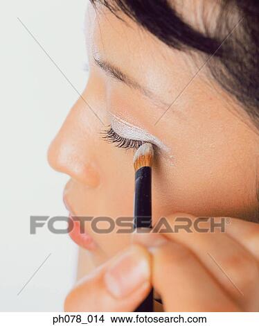 Young woman applying eye shadow View Large Photo Image Picture - Young woman applying eye shadow. Fotosearch