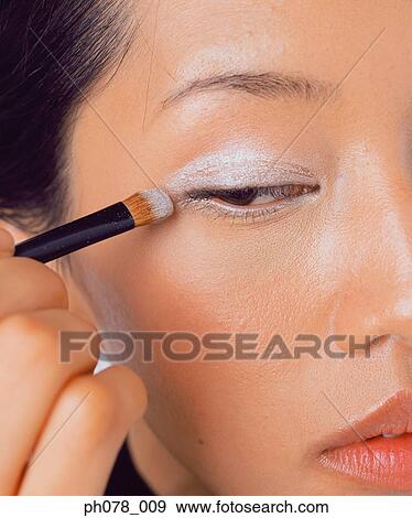 Young woman applying eye shadow View Large Photo Image Stock Photo - Young woman applying eye shadow. Fotosearch