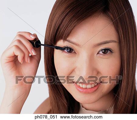 Young woman applying mascara View Large Photo Image Stock Image - Young woman applying mascara. Fotosearch