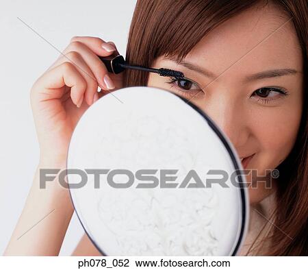 Young woman applying mascara View Large Photo Image Stock Image - Young woman applying mascara. Fotosearch