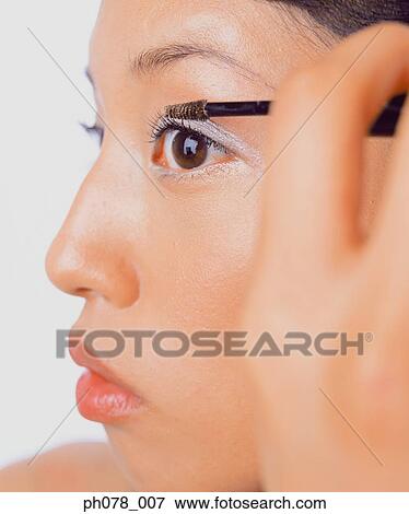 Young woman applying mascara View Large Photo Image Stock Photo - Young woman applying mascara. Fotosearch
