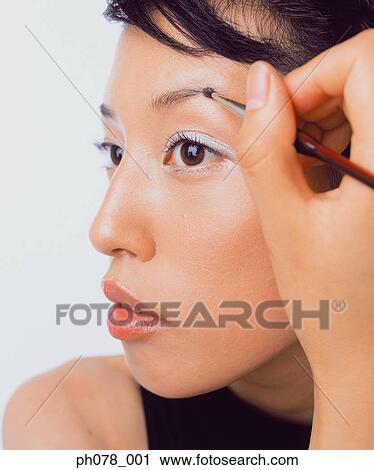 Young woman using eyebrow brush View Large Photo Image Stock Image - Young woman using eyebrow brush. Fotosearch