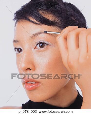 Young woman using eyebrow brush View Large Photo Image Stock Image - Young woman using eyebrow brush. Fotosearch