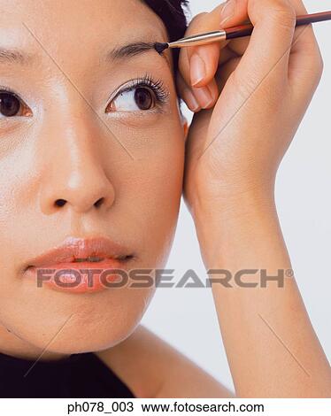 Young woman using eyebrow brush View Large Photo Image Stock Image - Young woman using eyebrow brush. Fotosearch