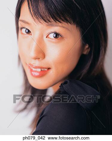 Young woman, close-up, looking over shoulder, portrait View Large Photo Image Stock Image - Young woman, close-up, looking over shoulder, portrait. Fotosearch
