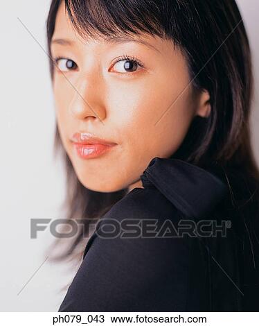 Young woman, close-up, looking over shoulder, portrait View Large Photo Image Stock Image - Young woman, close-up, looking over shoulder, portrait. Fotosearch