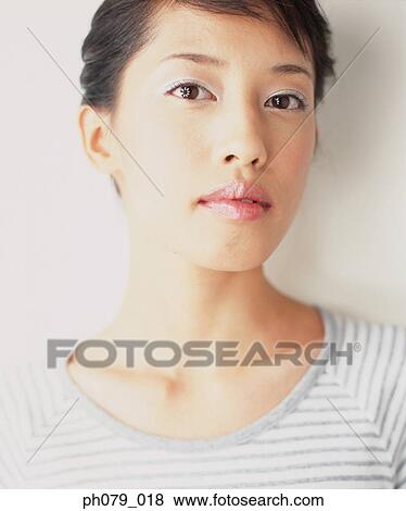 Stock Photo - Young woman, close-up, portrait. Fotosearch