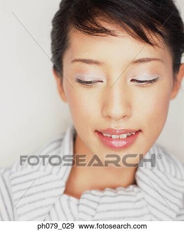 Stock Photo - Young woman, eyes closed, close-up, portrait. Fotosearch