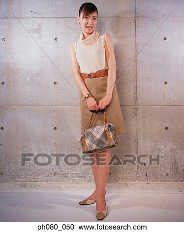 Stock Image - Portrait of a smiling woman, posing. Fotosearch