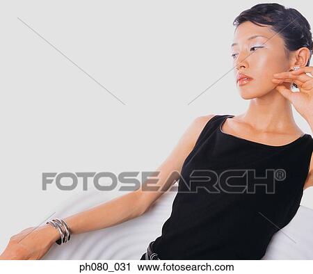 Portrait of a young woman sitting, Confident pose View Large Photo Image Stock Image - Portrait of a young woman sitting, Confident pose. Fotosearch