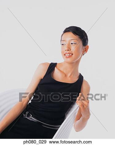 Portrait of a young woman sitting, Confident pose View Large Photo Image Stock Photo - Portrait of a young woman sitting, Confident pose. Fotosearch