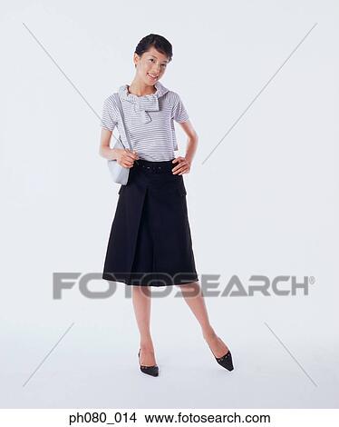 Young woman carrying handbag, hand on hip View Large Photo Image Picture - Young woman carrying handbag, hand on hip . Fotosearch